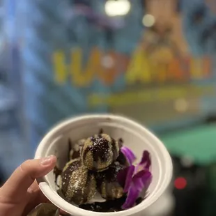 a person holding a bowl of food