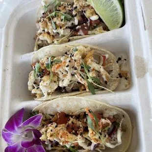 three tacos in a styrofoam container