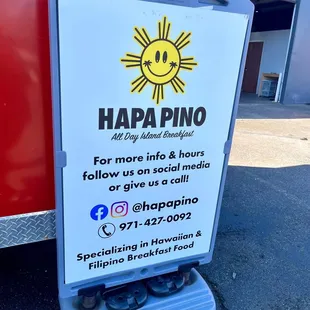 a sign in front of a food truck