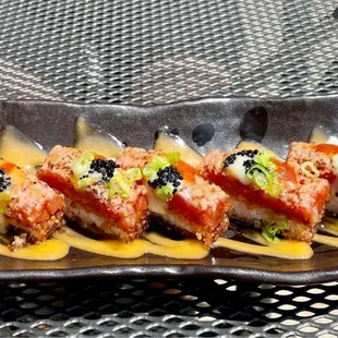 Sweet and spicy tuna topped with a special sauce and fish eggs all nestled on a bed of delicious crispy rice.