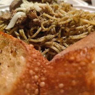 a plate of spaghetti with meat and bread
