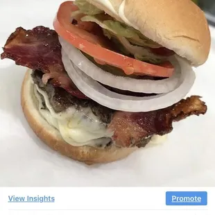 a hamburger with bacon and cheese