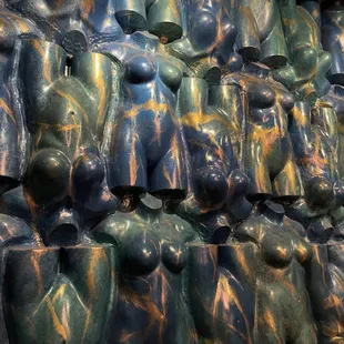 a wall of blue and green sculptures