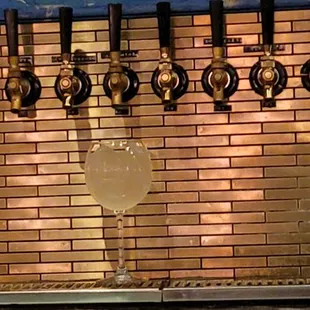 a row of beer taps in a bar
