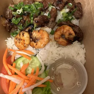 Rice with grilled pork and shrimp skewers