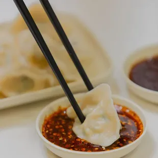 Homemade fresh dumplings dipped in our fresh homemade chili crunch sauce.