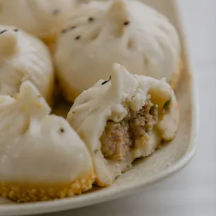 Classic Sheng Jian Bao, featuring a soft puffy steamed top and a crispy golden pan-fried bottom and a fresh meatball filling!