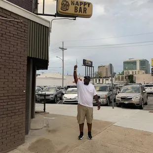 a man holding up a beer