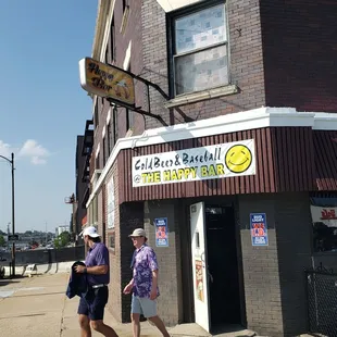 two men walking down the sidewalk