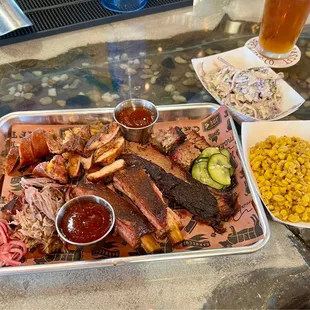 a platter of meat and sides