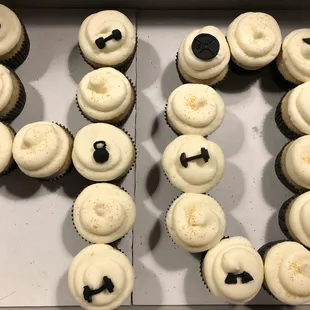 Gluten free vanilla cupcakes with vanilla buttercream and edible barbells, kettle bells, and weight plates!