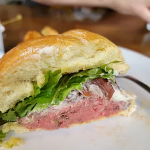 Rare roast beef sandwich on Kaiser bun.