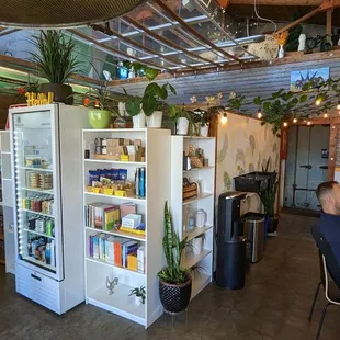 a man sitting at a table in front of a refrigerator