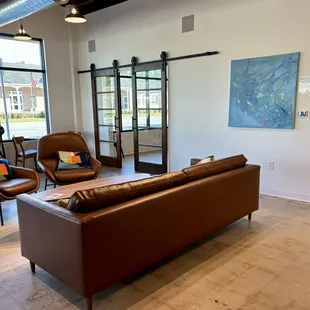 a living room with a couch and chairs