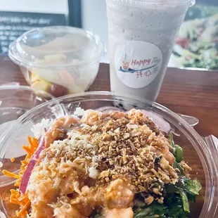 Delicious taro boba tea, spicy salmon poke bowl and cup of fresh fruit.