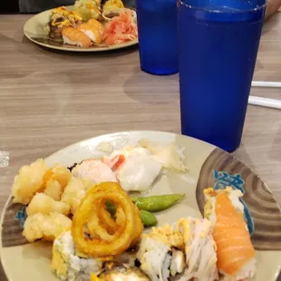 a plate of sushi and a glass of water