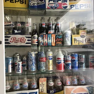 a display case full of pepsi cans