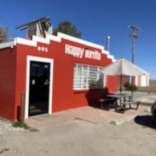 a car parked in front of a red building