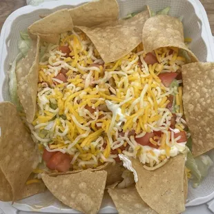 Super taco..one tiny taco is under all the lettuce, chips, cheese and other side toppings