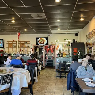 people sitting at tables in a restaurant