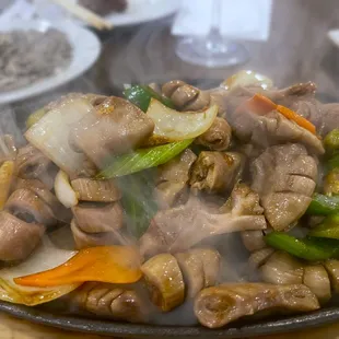 a plate of stir fried meat and vegetables