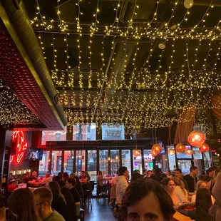 people sitting at tables in a restaurant