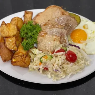 Pork with Potatoes a fresh salad and a side of egg