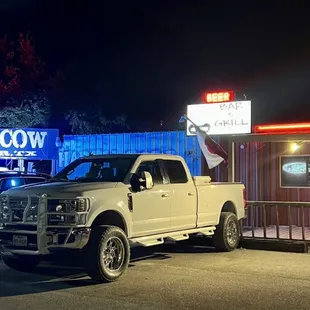 a truck parked in front of a restaurant