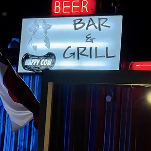 a neon sign for a bar and grill