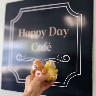 a hand holding a teddy bear