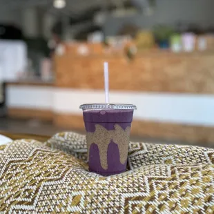 a purple cup with a straw