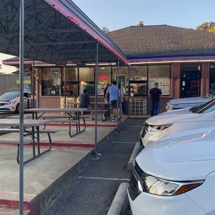 the front of a restaurant with a car parked in front of it
