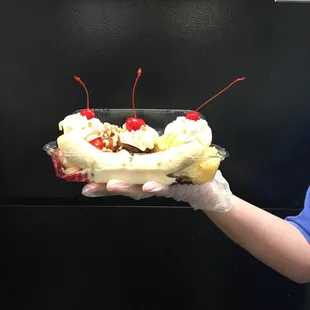a person holding a banana split