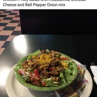 a plate of salad with cheese and lettuce