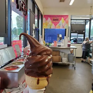 a person holding a cone of ice cream