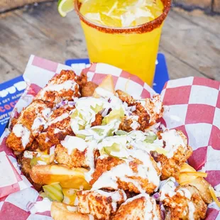 LOADED SMILEY FRIES: housemade tenders, steak fries, jack &amp; cheddar cheese, pickles, onions, cheese sauce, buttermilk ranch