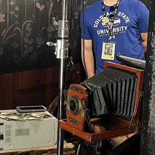 a man holding an old camera