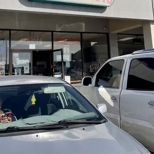a car parked in front of a donut shop