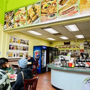 people sitting at a counter in a fast food restaurant