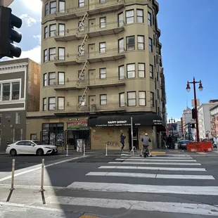 a street corner with a building in the background