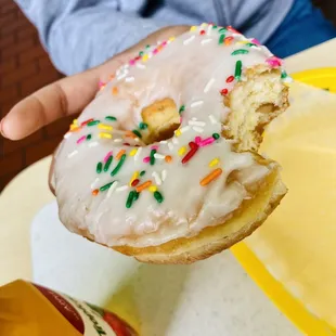 a half eaten donut with sprinkles