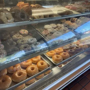 a variety of donuts in a display case