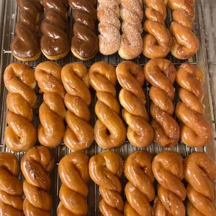 a variety of doughnuts on a cooling rack