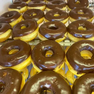 chocolate frosted donuts on a cooling rack