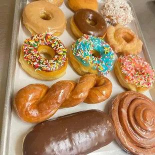 a variety of doughnuts on a tray