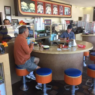 Interior of donut shop with friendly old guys chit chatting