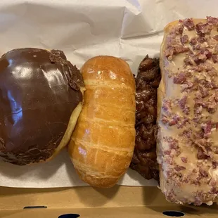 Left to right: Bavarian cream Fill, Kolaches, Bacon Maple Bar and Apple Fritter (under)