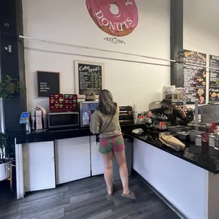 a woman standing in front of the counter