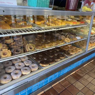 a variety of donuts in a display case