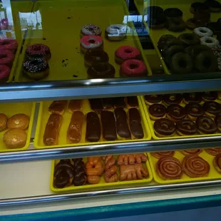 a variety of donuts in a display case